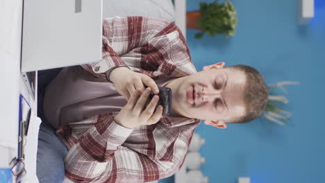 Vertical-video-of-Home-office-worker-man-texting.